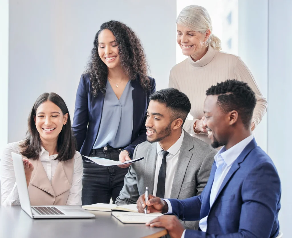 group gathered around laptop